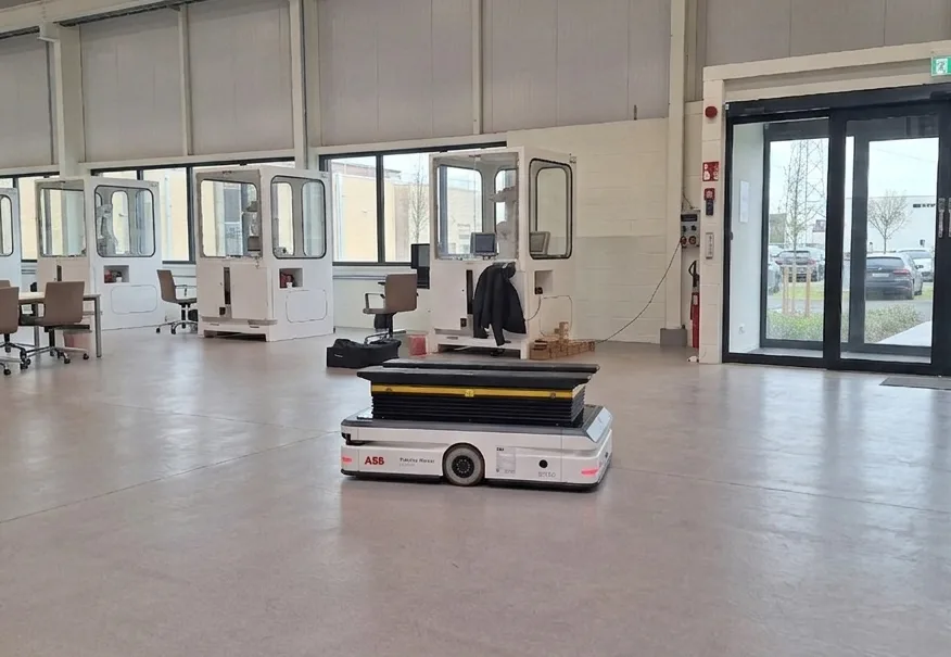 An ABB autonomous mobile robot with a lift-top module on a facility floor